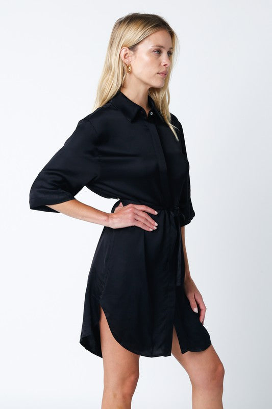 Black silky button front shirt dress with tie waist belt, collared neck, and half sleeves.