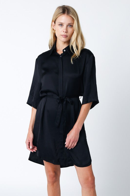 Black silky button front shirt dress with tie waist belt, collared neck, and half sleeves.