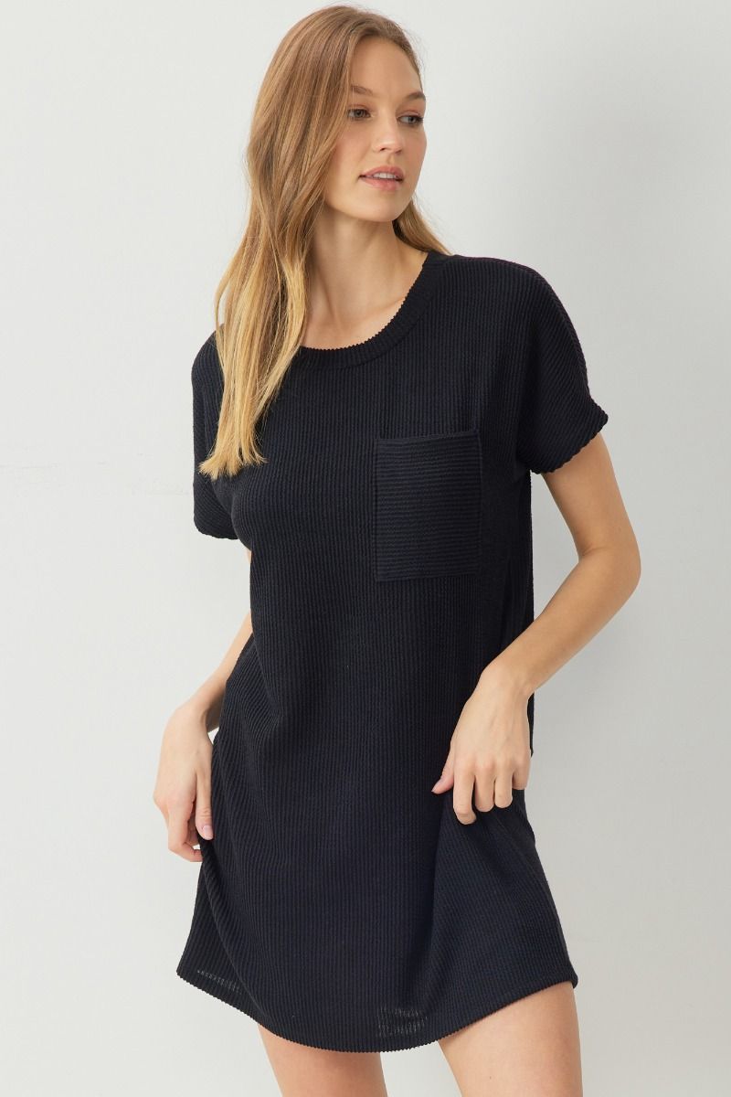 Ribbed round neck short sleeve mini dress featuring pocket at bust. Unlined. Knit. Non-sheer. Lightweight.
