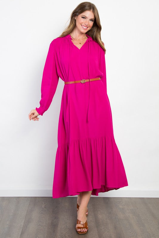 Fuchsia long sleeve midi dress with tie neck and ruffle detailing paired with belt