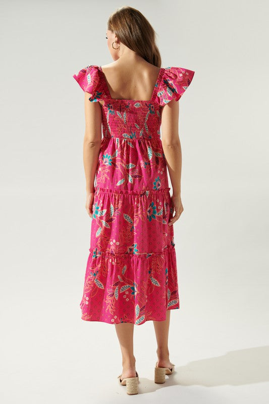 Pink cotton midi dress with paisley print, smocked bust, tiered skirt, and ruffle shoulder straps.