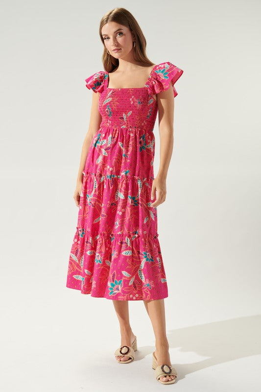 Pink cotton midi dress with paisley print, smocked bust, tiered skirt, and ruffle shoulder straps.