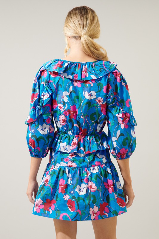 Blue cotton poplin dress with v-neck, ruffle details, 3/4 sleeves and tiered skirt.