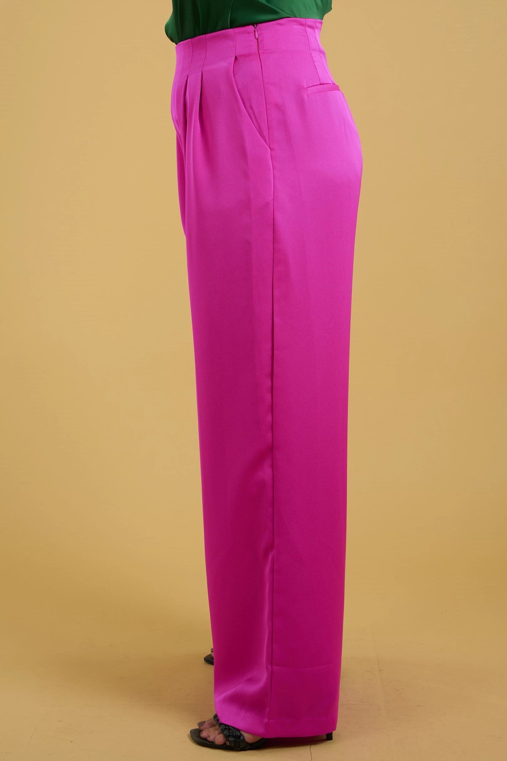 Magenta silky wide leg pants with high waist, side pockets, hidden side zipper, and tailored pleat details. 